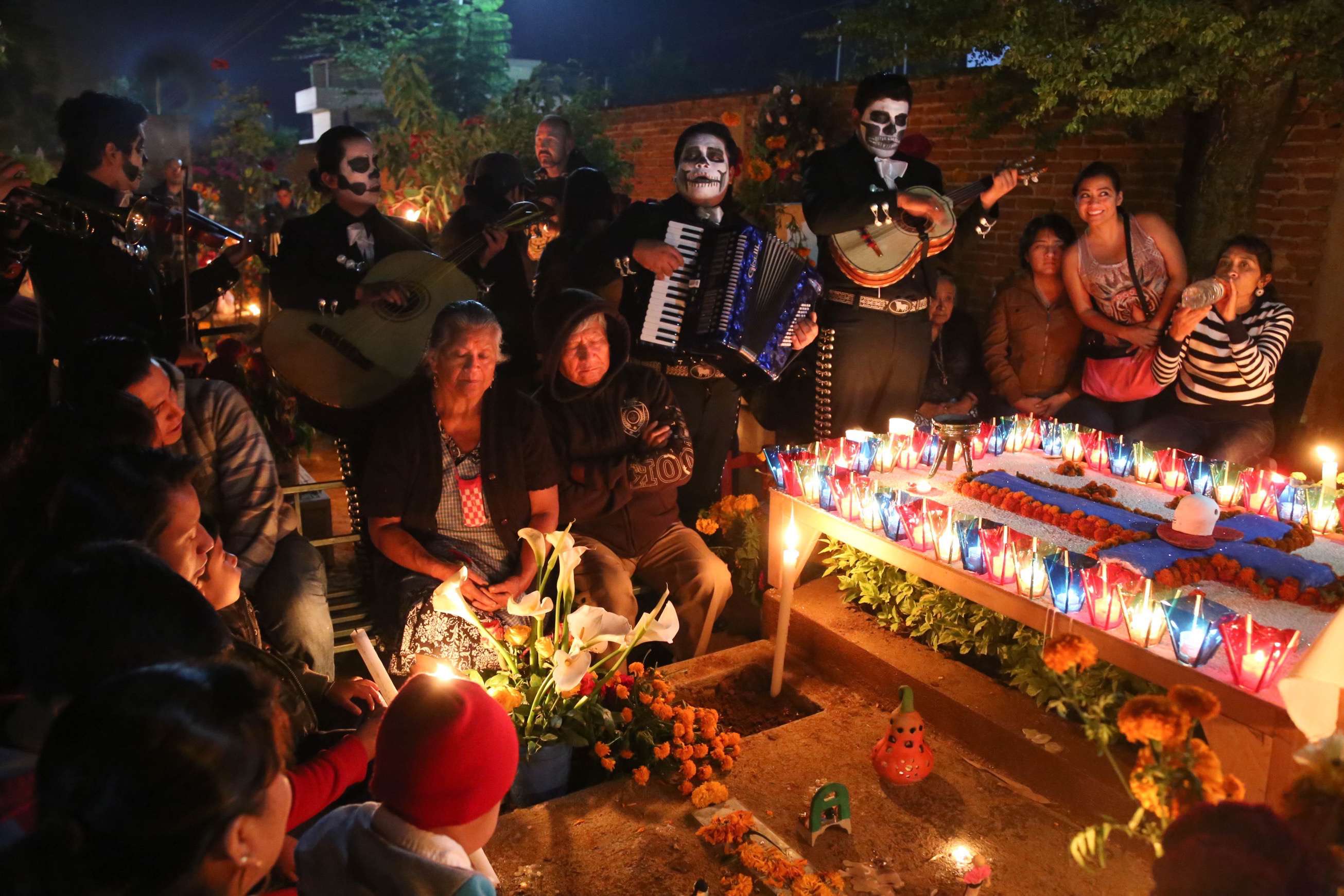 At the Santa Cruz Xoxocotlan Cemetery family, friends and musicians gather to remember a loved one and to celebrate life.